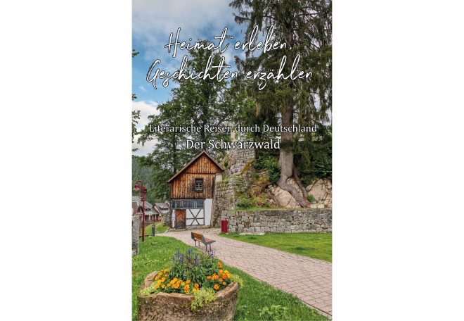 Ein Haus am Weg, umgeben von Bäumen und bunten Blumenbeeten.