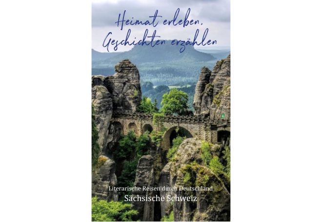 Ein malerisches Landschaftsbild mit felsigen Bergen und einer Brücke in der Ferne.