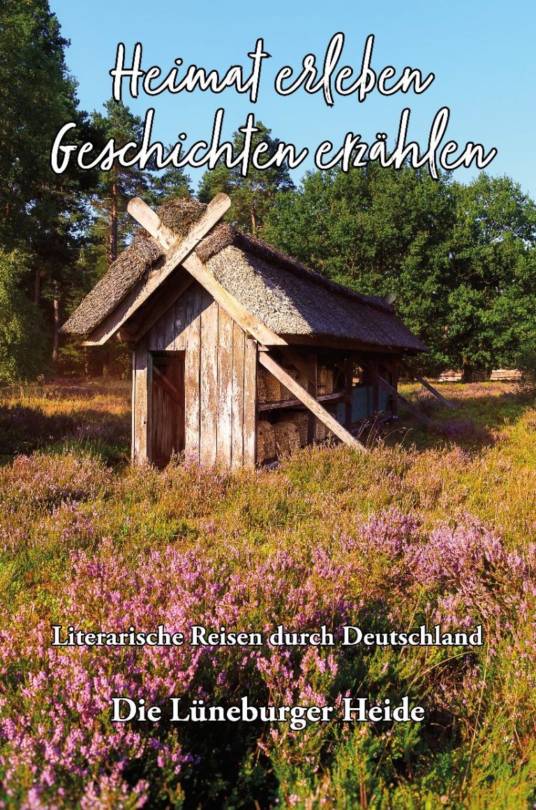 Ein Frau sitzt an einem Tisch mit Büchern und Glücksmomenten, umgeben von bunten Deko-Elementen.